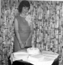 1964 Dorothy McCann Collins cuts the wedding cake in Kensington, CA home